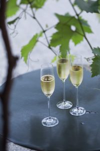 Drei Gläser Sekt auf einem Tisch im Freien
